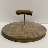 Vintage round wooden cheese board covered with glass plate with foldable handle