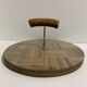 Vintage round wooden cheese board covered with glass plate with foldable handle