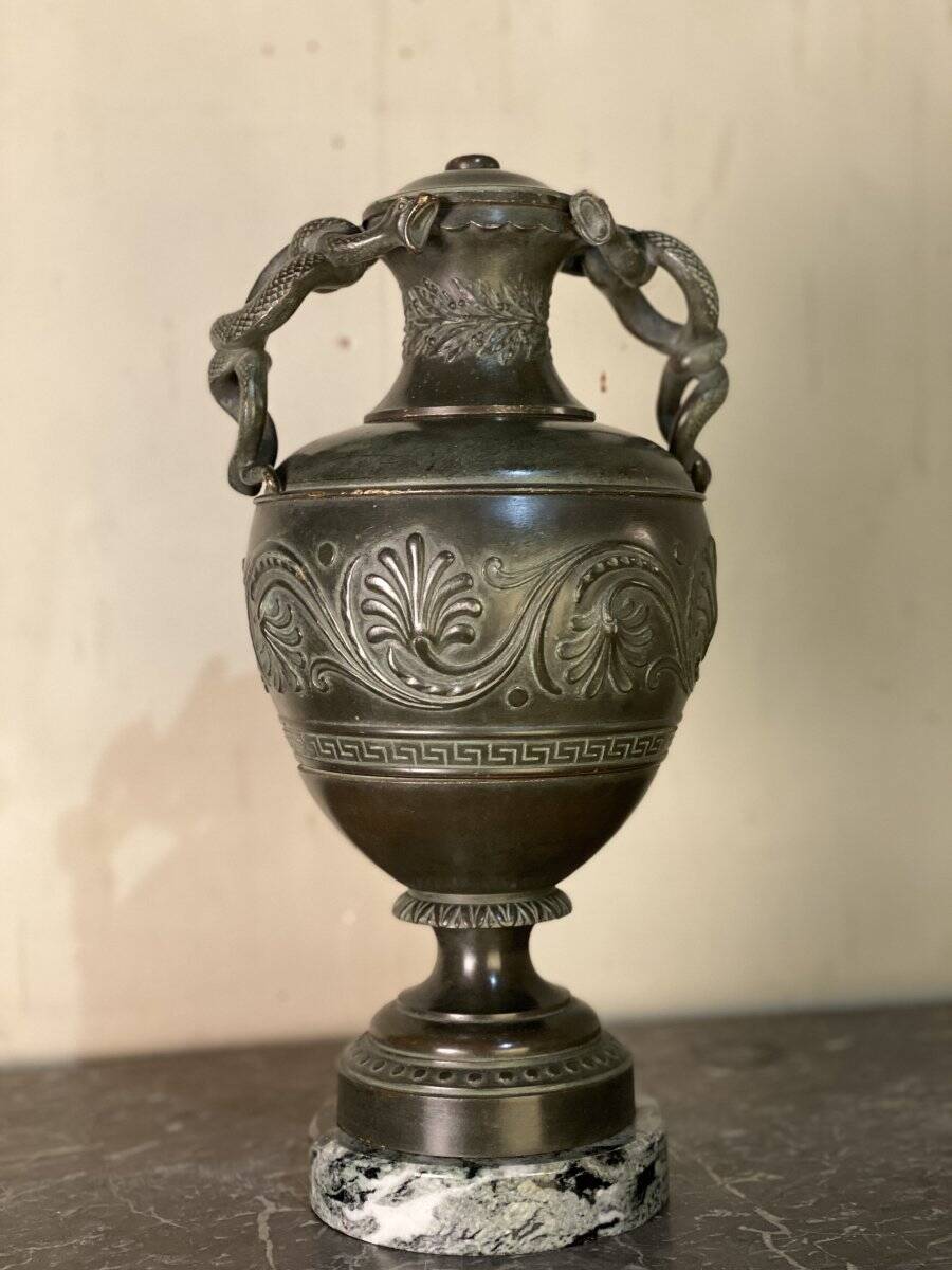 Bronze vase with snakes and a green patina, in the antique style.