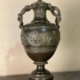 Bronze vase with snakes and a green patina, in the antique style.