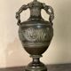 Bronze vase with snakes and a green patina, in the antique style.