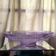 Twisted glass fruit cup of purplish pink color