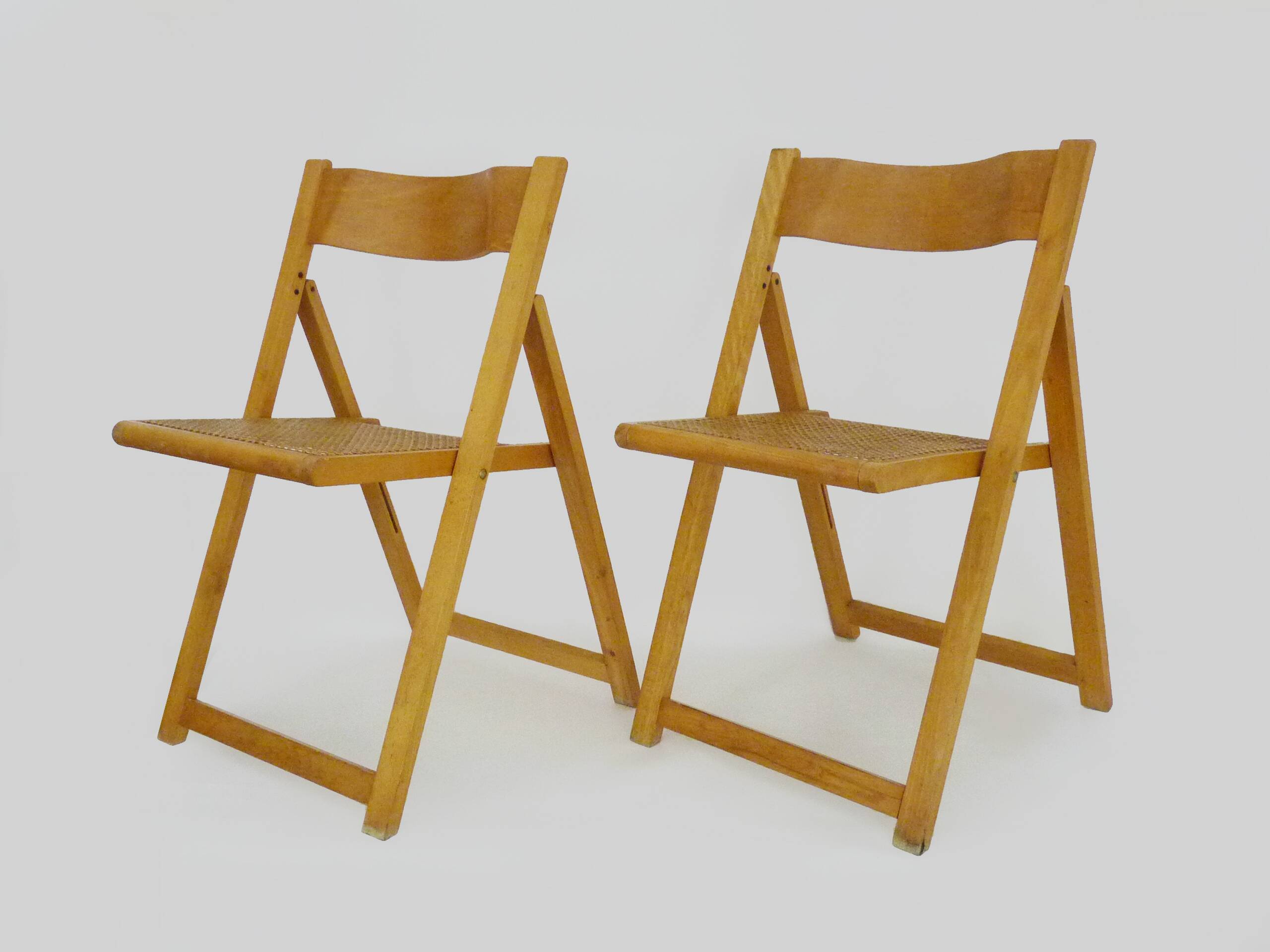 Pair of vintage folding chairs in beech and canework. Italy 70s