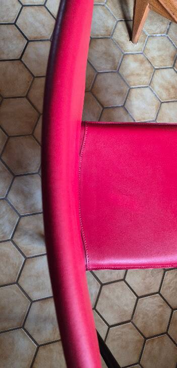 Red leather chairs by Arper