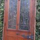 Oak entrance door and its frame and transom, wrought iron gates