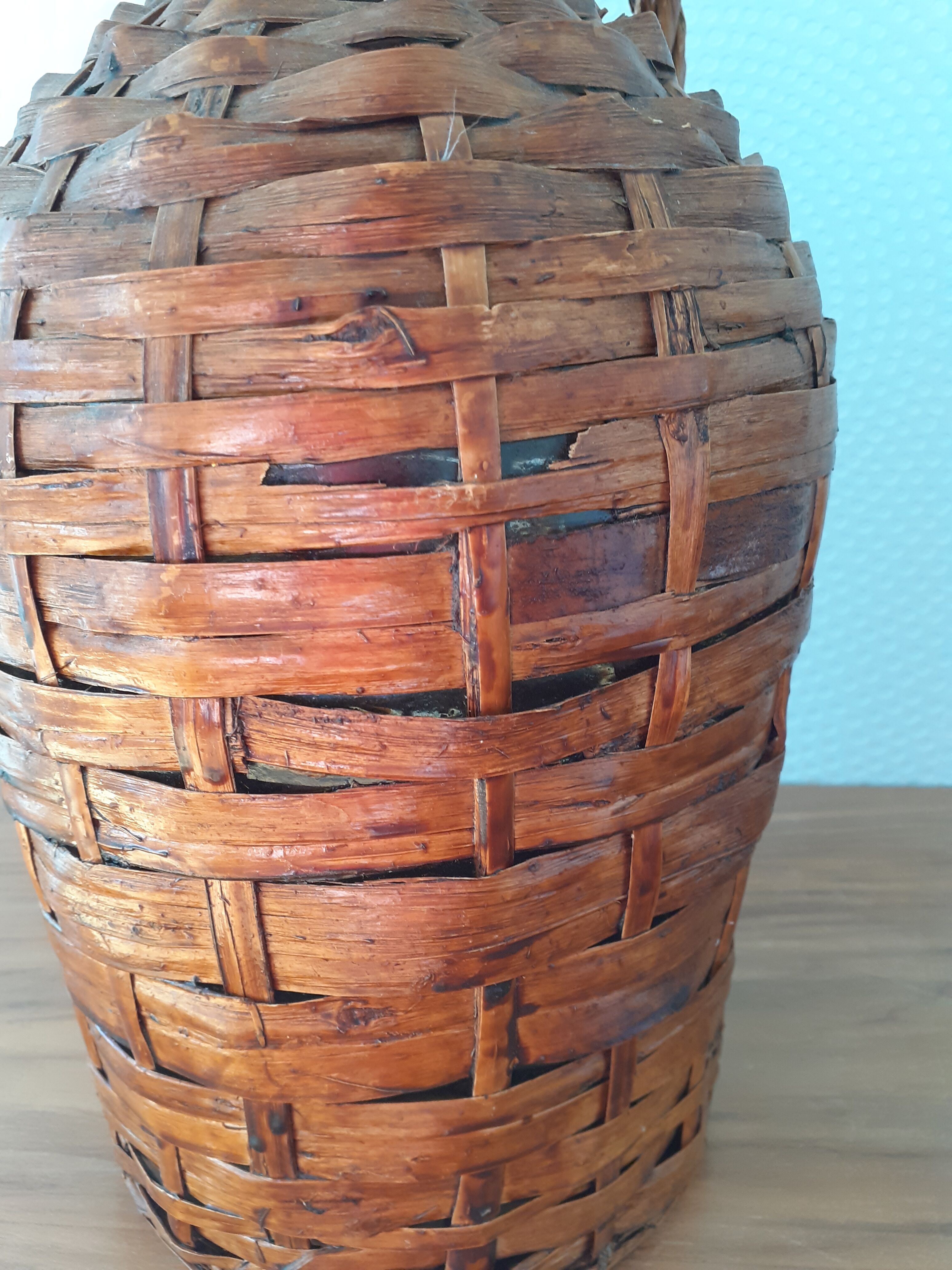 Demijohn surrounded by wicker
