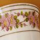 Footed glass in the shape of a chalice in white opaline with a floral decoration.