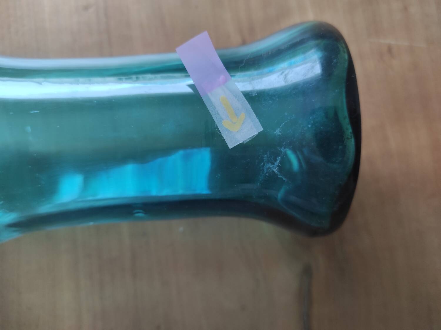 Blown glass vase with a flared neck and wavy rim.