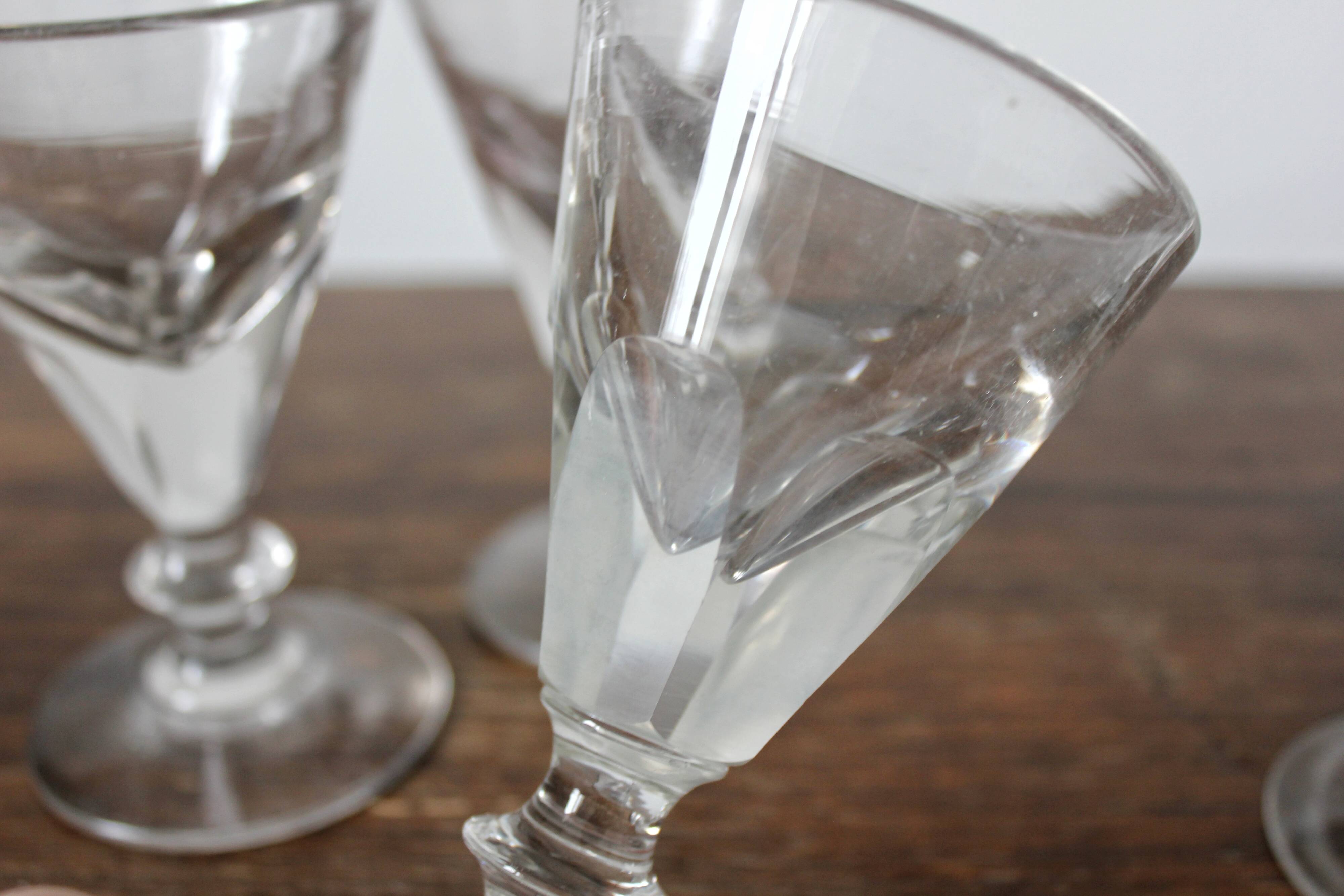 4 antique stemmed wine glasses with flat sides, made of blown glass from the 19th century