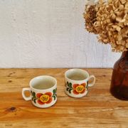 A pair of vintage Weidmann cups with an orange flower motif from the 1970s.