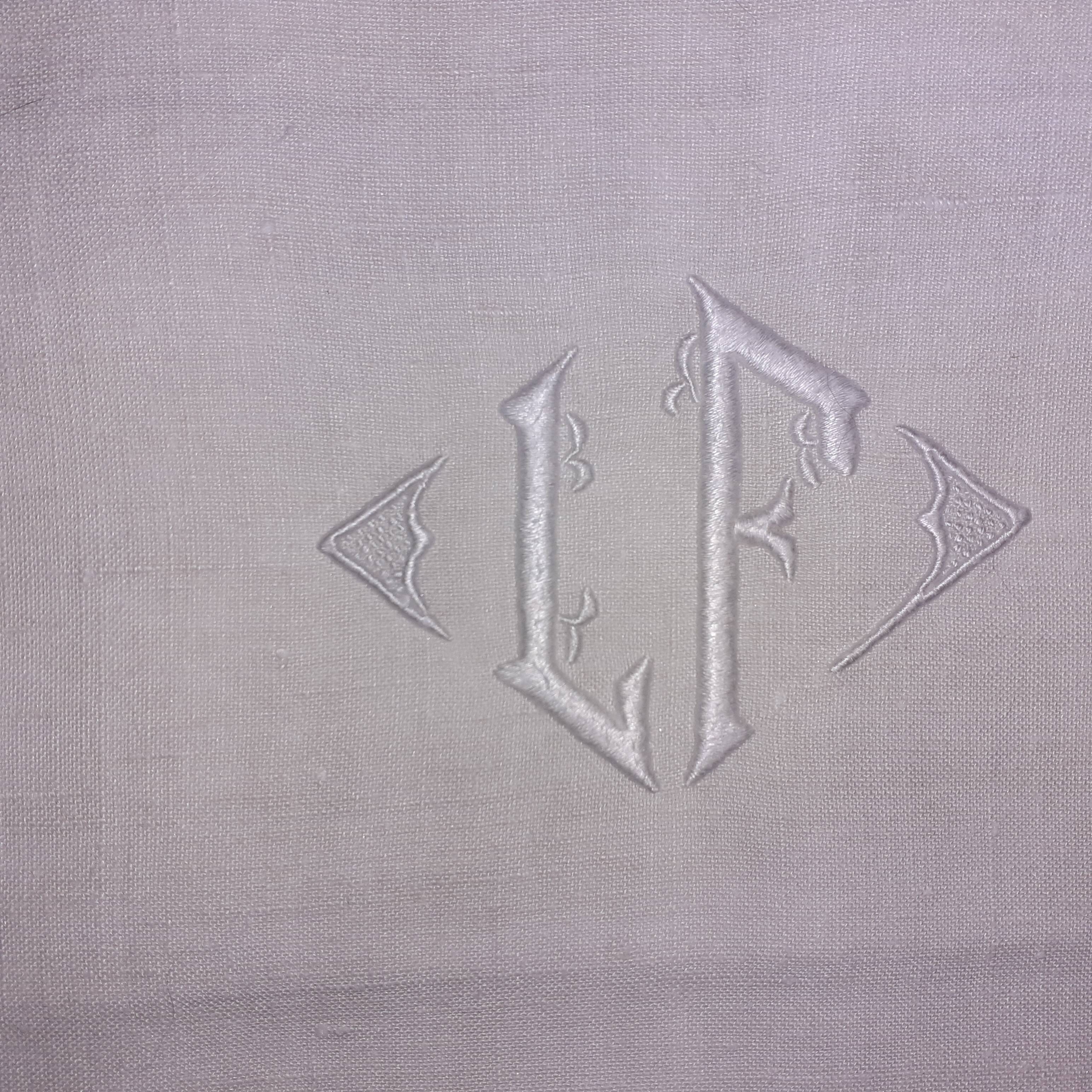 9 old linen towels with monogram in the center.