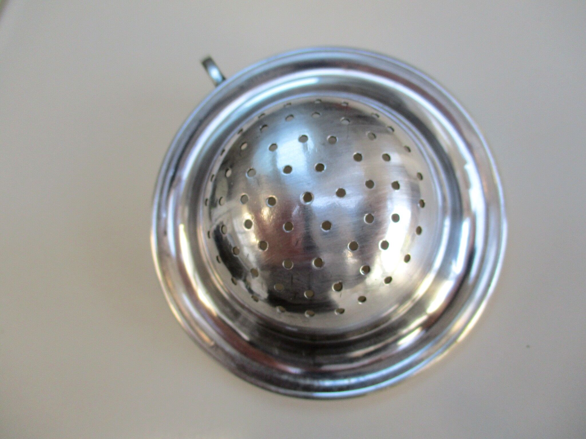 Silver metal tea strainer