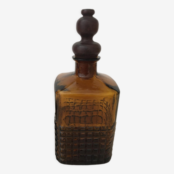 Old amber glass bottle with its wooden and cork stopper