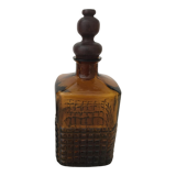 Old amber glass bottle with its wooden and cork stopper