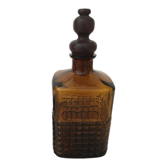 Old amber glass bottle with its wooden and cork stopper