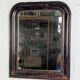 Antique Louis Philippe mirror with a patinated black frame.