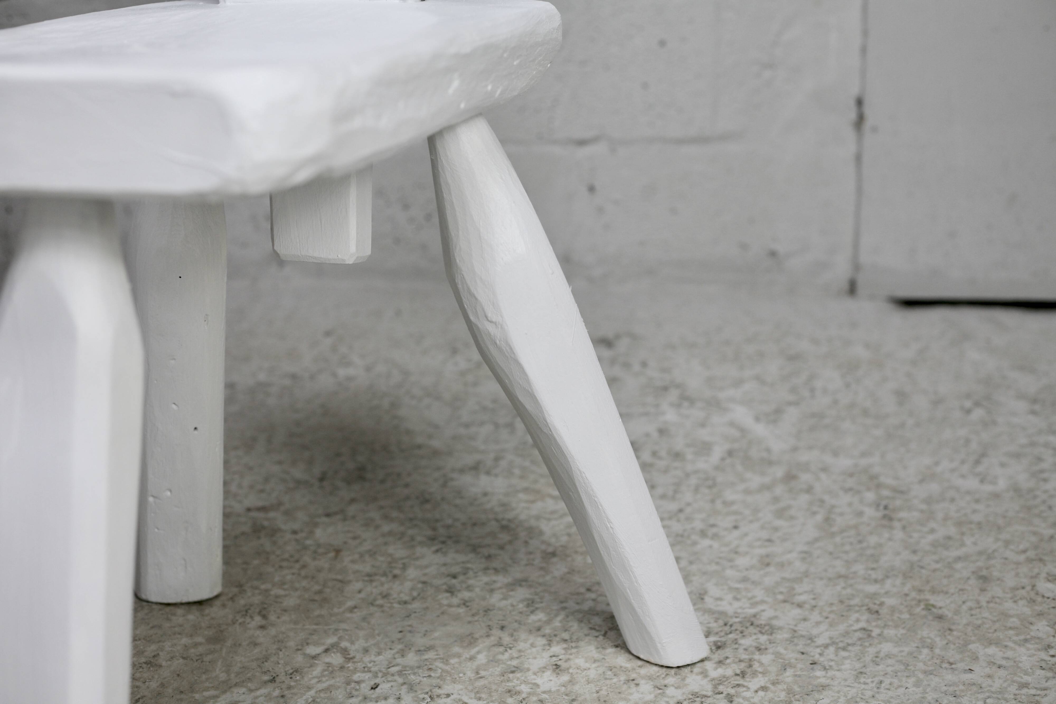 Pair of tripod chairs, gouged seats. Brutalist, circa 1960. Painted wood.