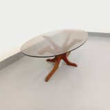 Vintage Hugues Poignant oval coffee table in teak and smoked glass from the 1970s