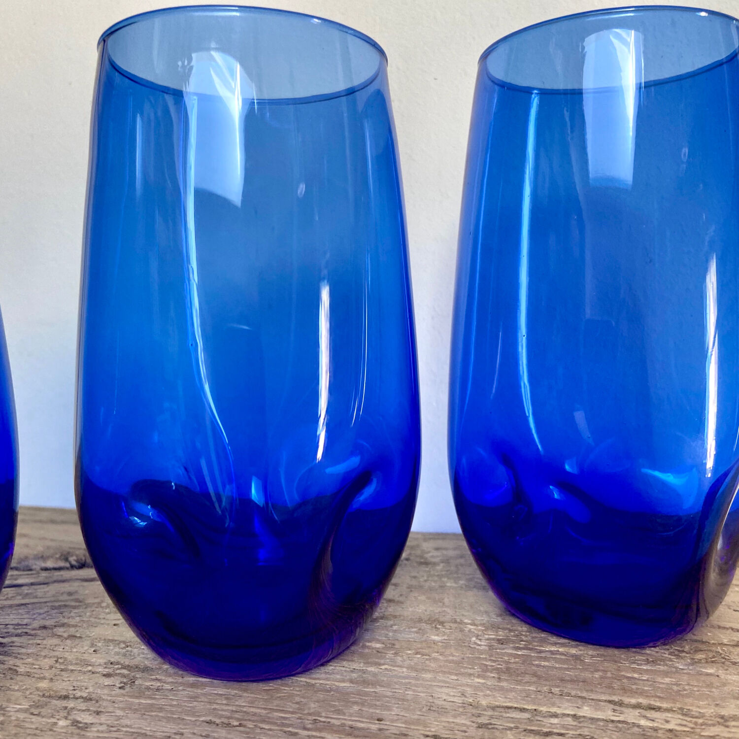 3 blue colored long drink glasses