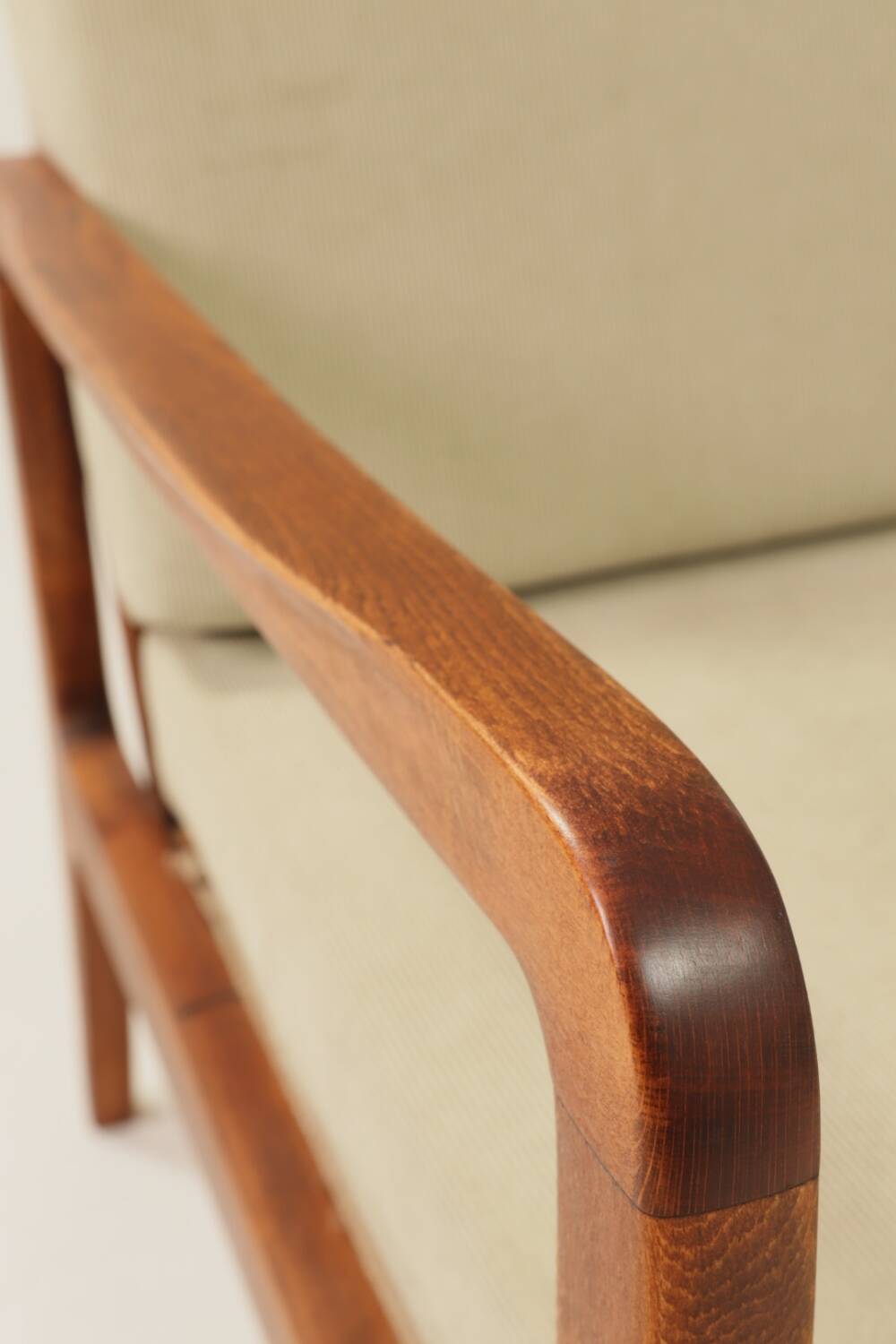 Vintage armchair in olive corduroy with a wooden frame.