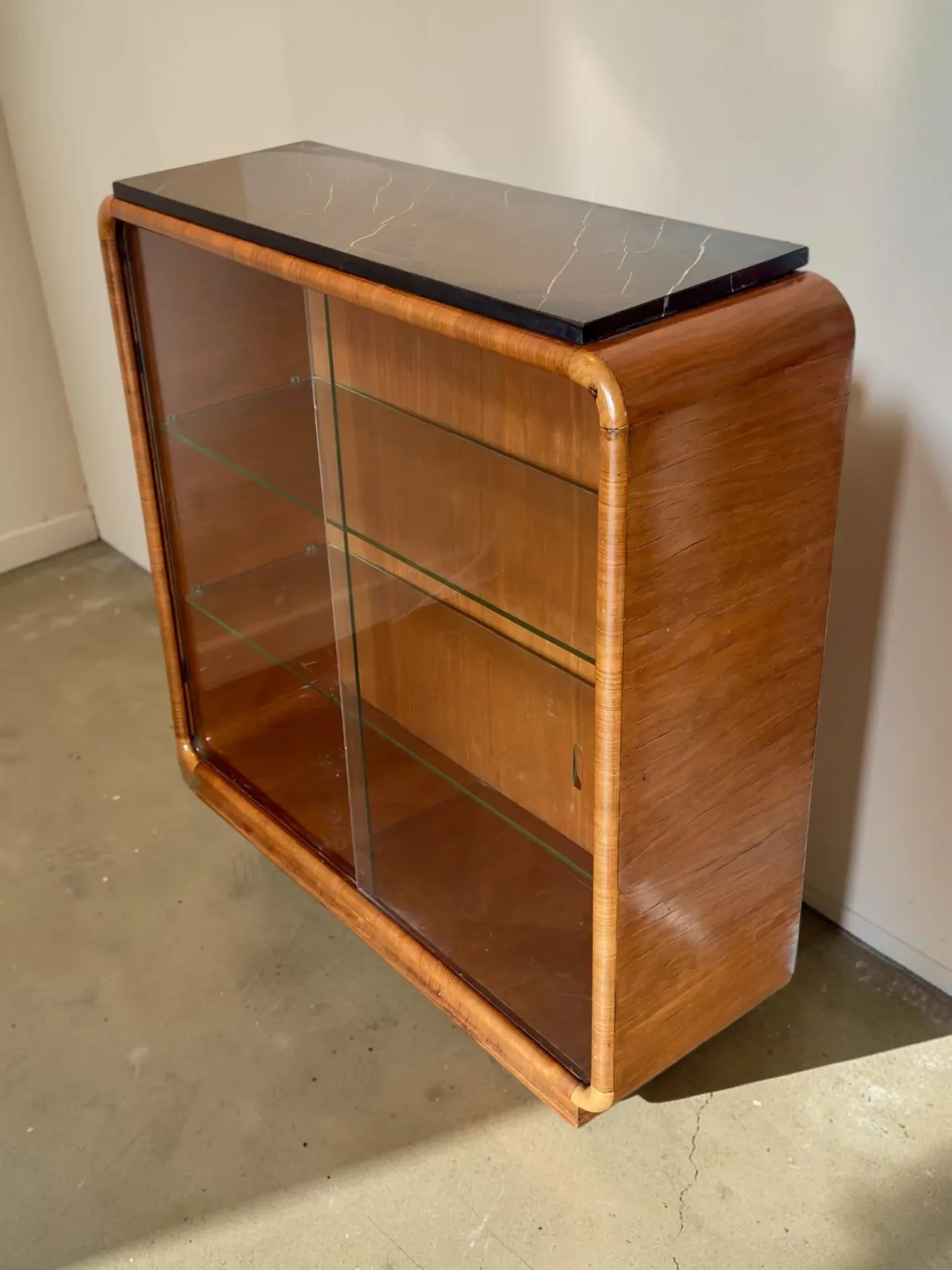 Vintage Art Deco display cabinet in mahogany with a black marble top.
