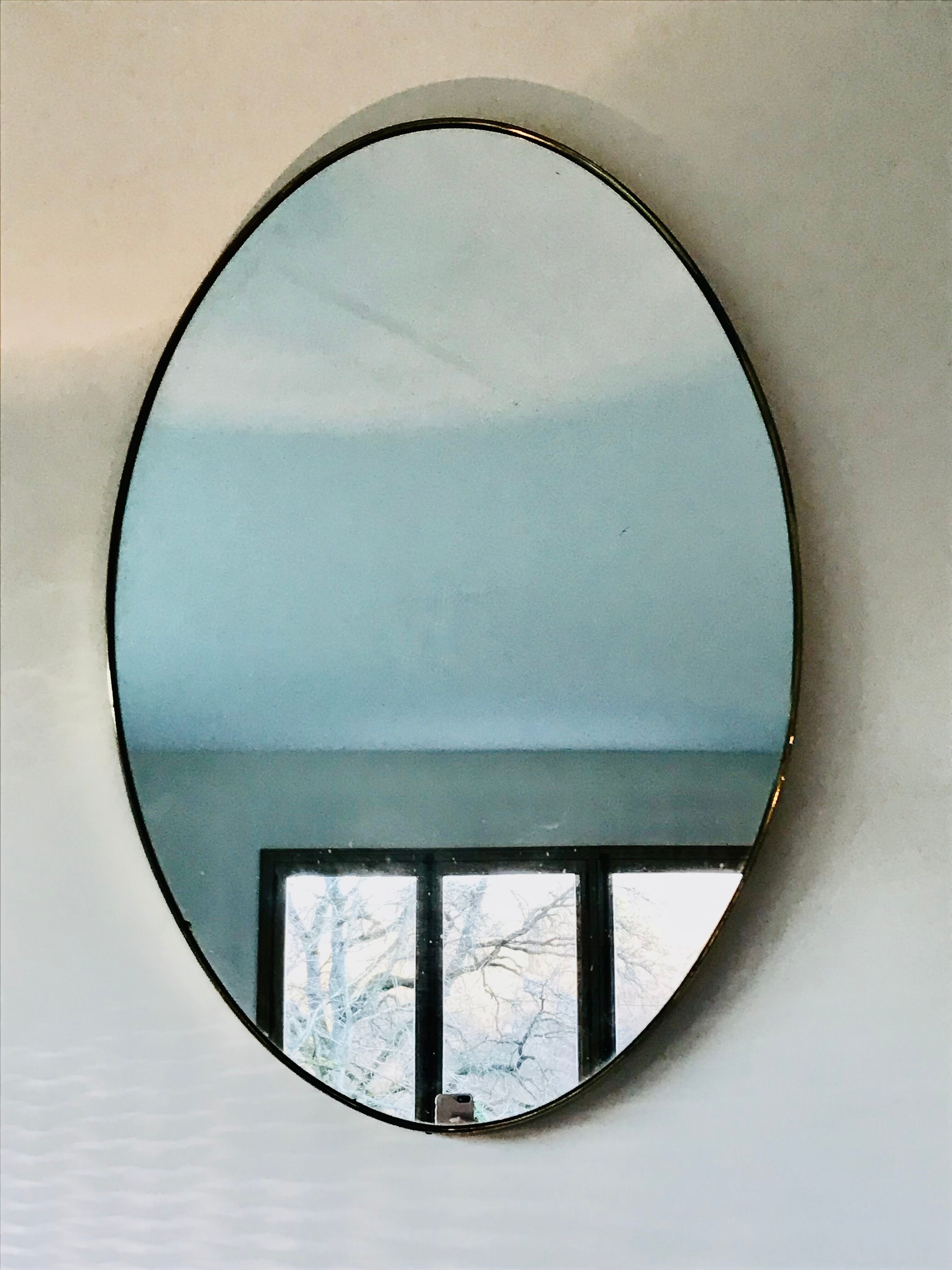 Oval brass mirror, Italy, circa 1960.