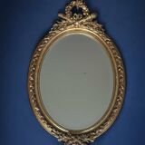 19th century oval gilded mirror, torch & quiver 106cm