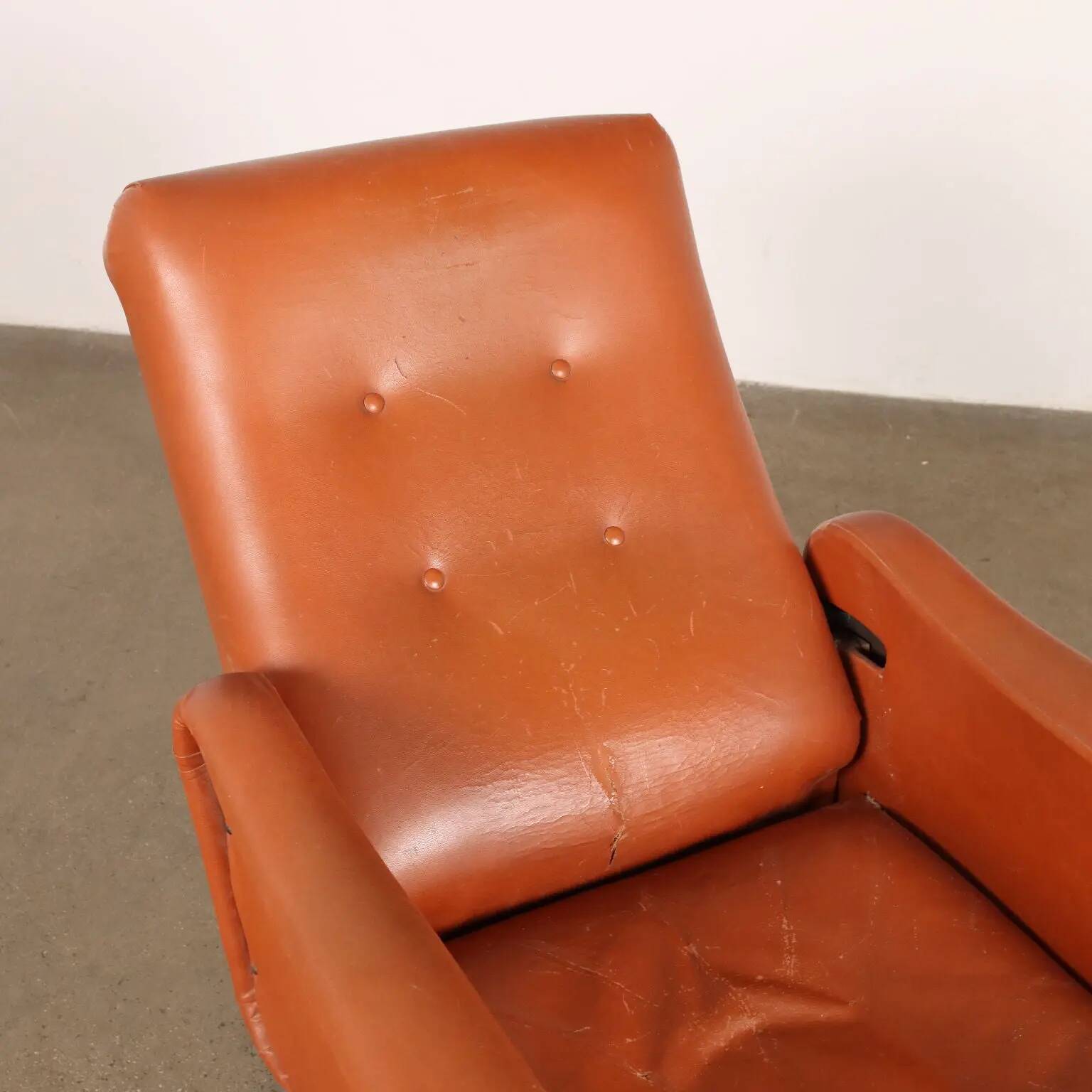 Vintage armchair from the 1970s in foam, faux leather, and metal.