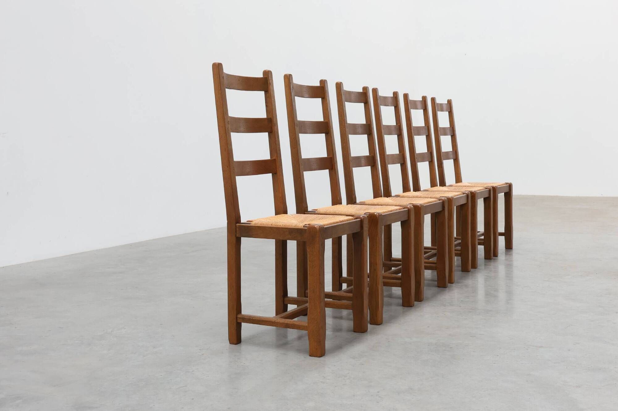 Set of 6 rustic oak ladder-back chairs with rush seats, France, 20th centur