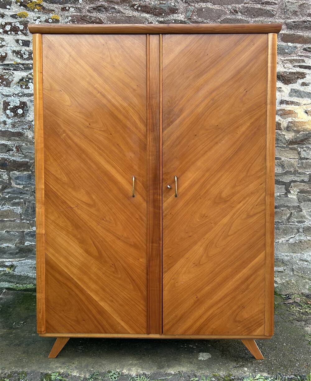Mid-century wardrobe from the 1960s in wood, with a chevron front and tapered legs.