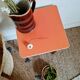 Wooden wax stool and orange formica
