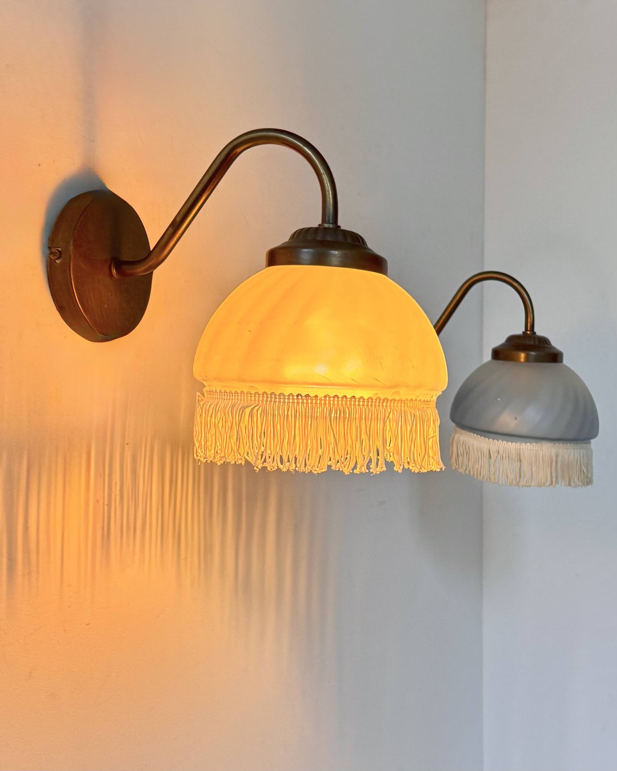 Pair of vintage wall lights in brass and blue-tinted glass, France 1970.