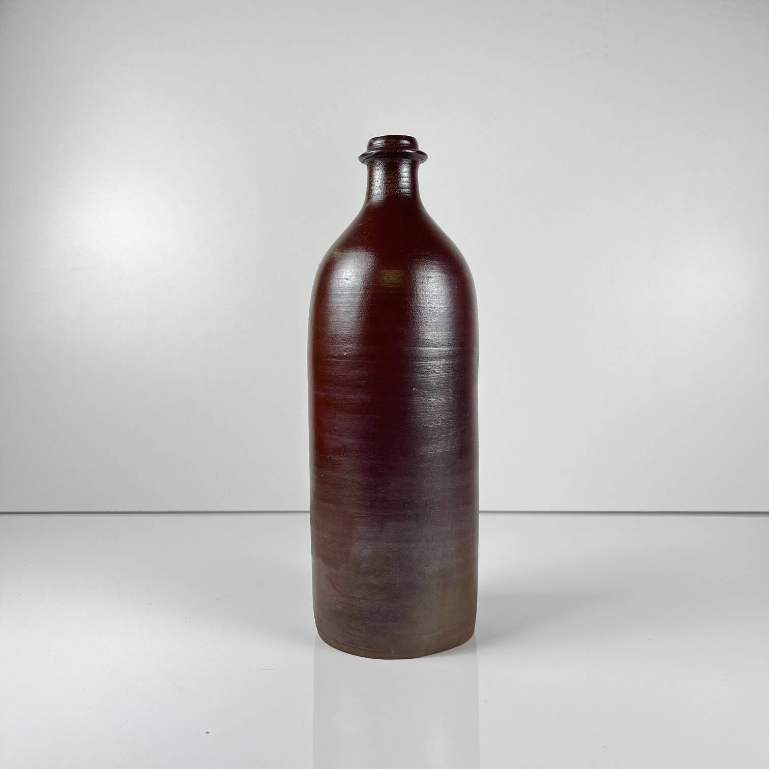 Duo of speckled stoneware and burgundy bottles, 20th century