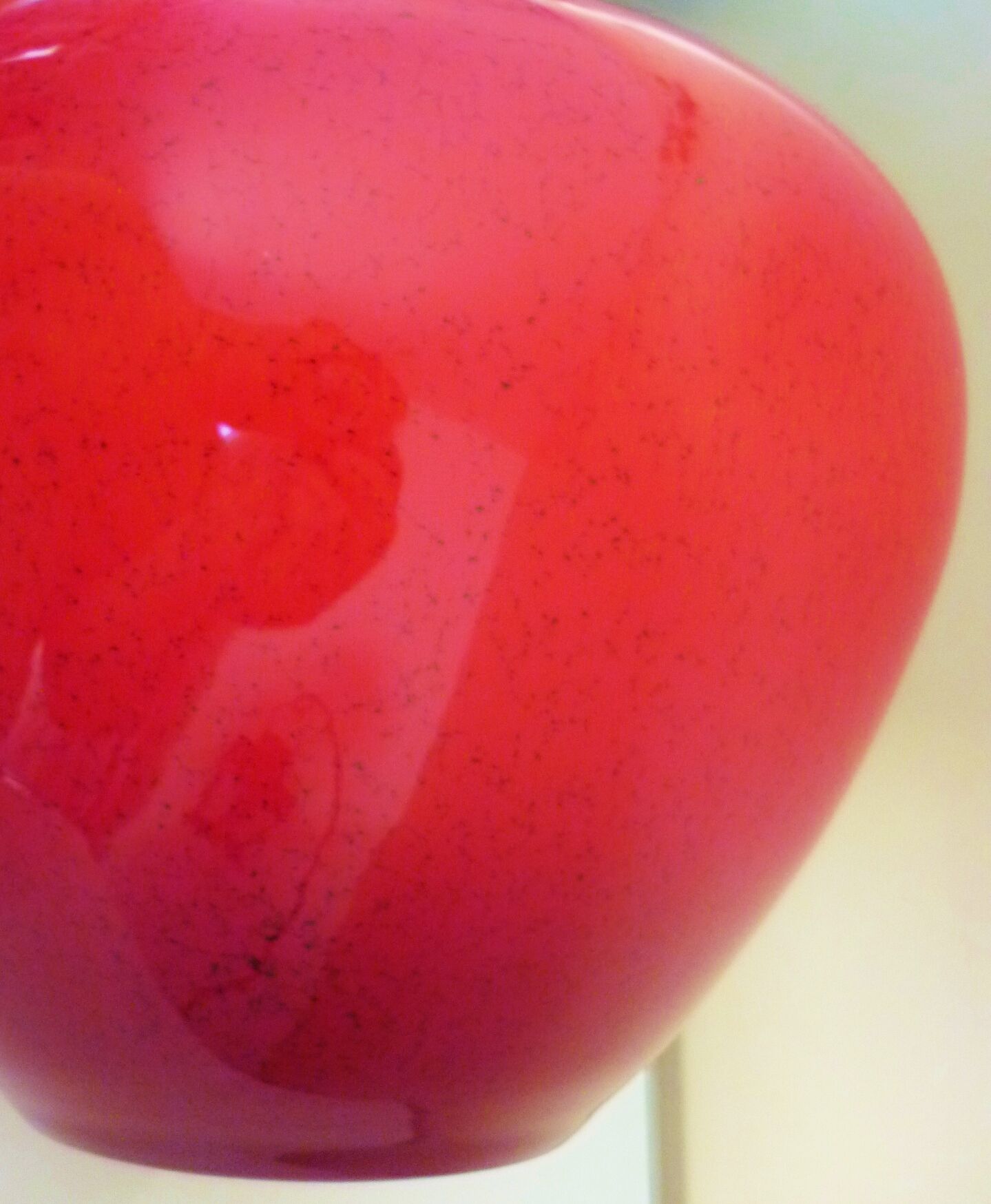 Pot-bellied, art deco vase in speckled ruby red multi-layered glass, white interior