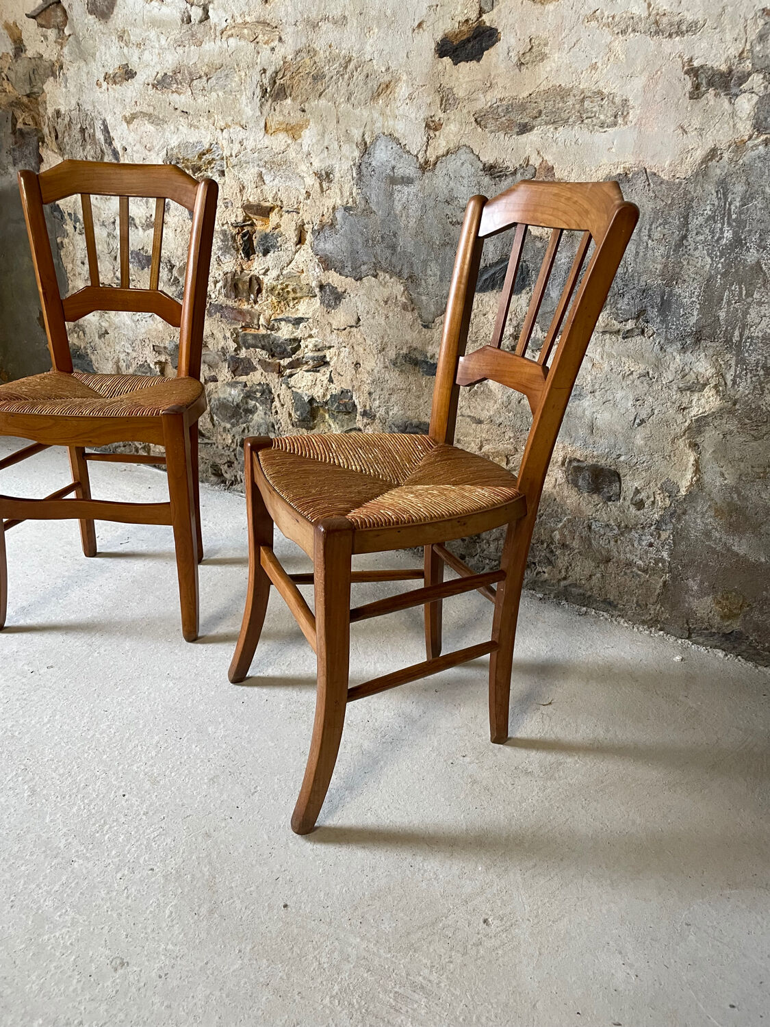 Set of 2 antique wooden and straw chairs.