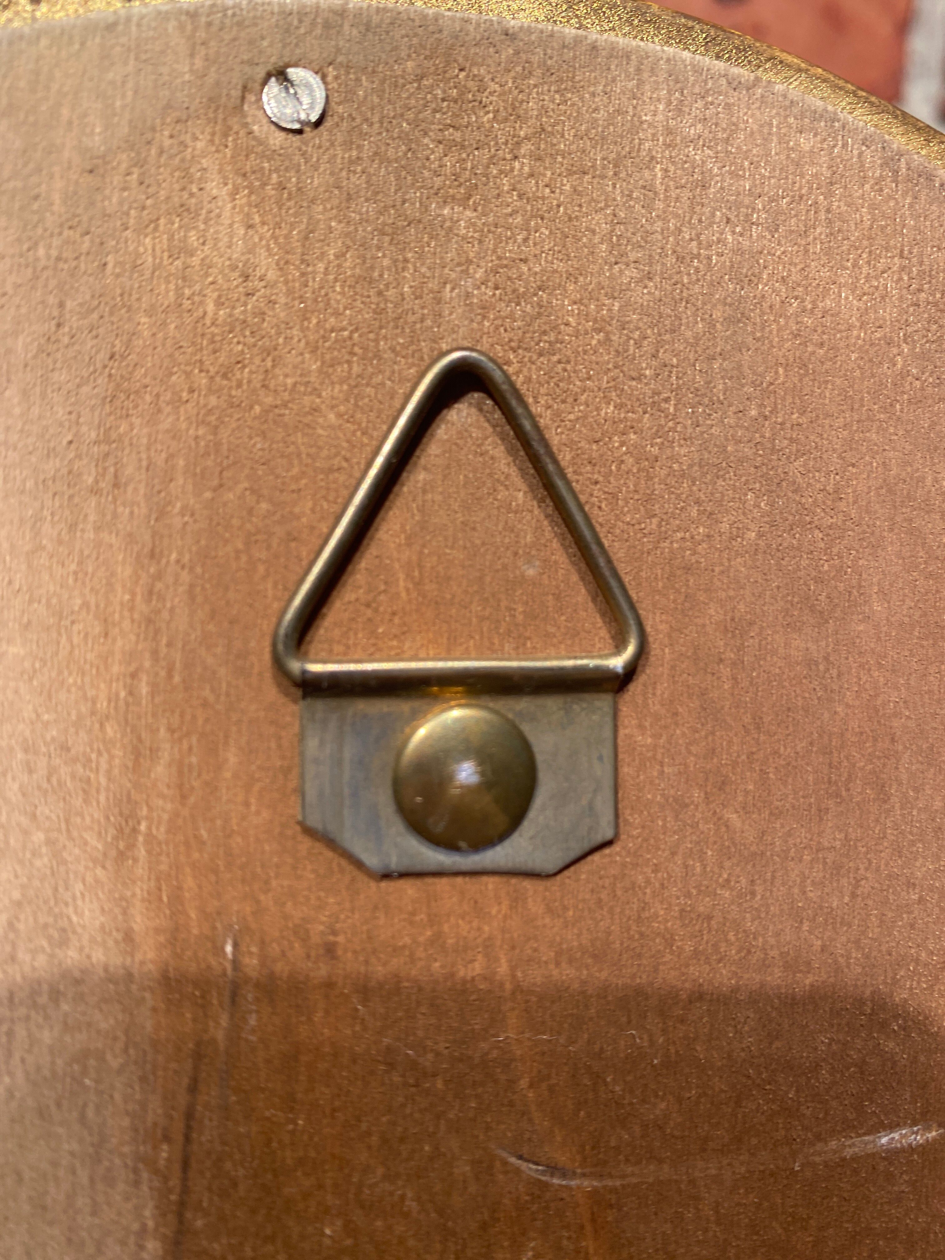 Oval mirror in a frame