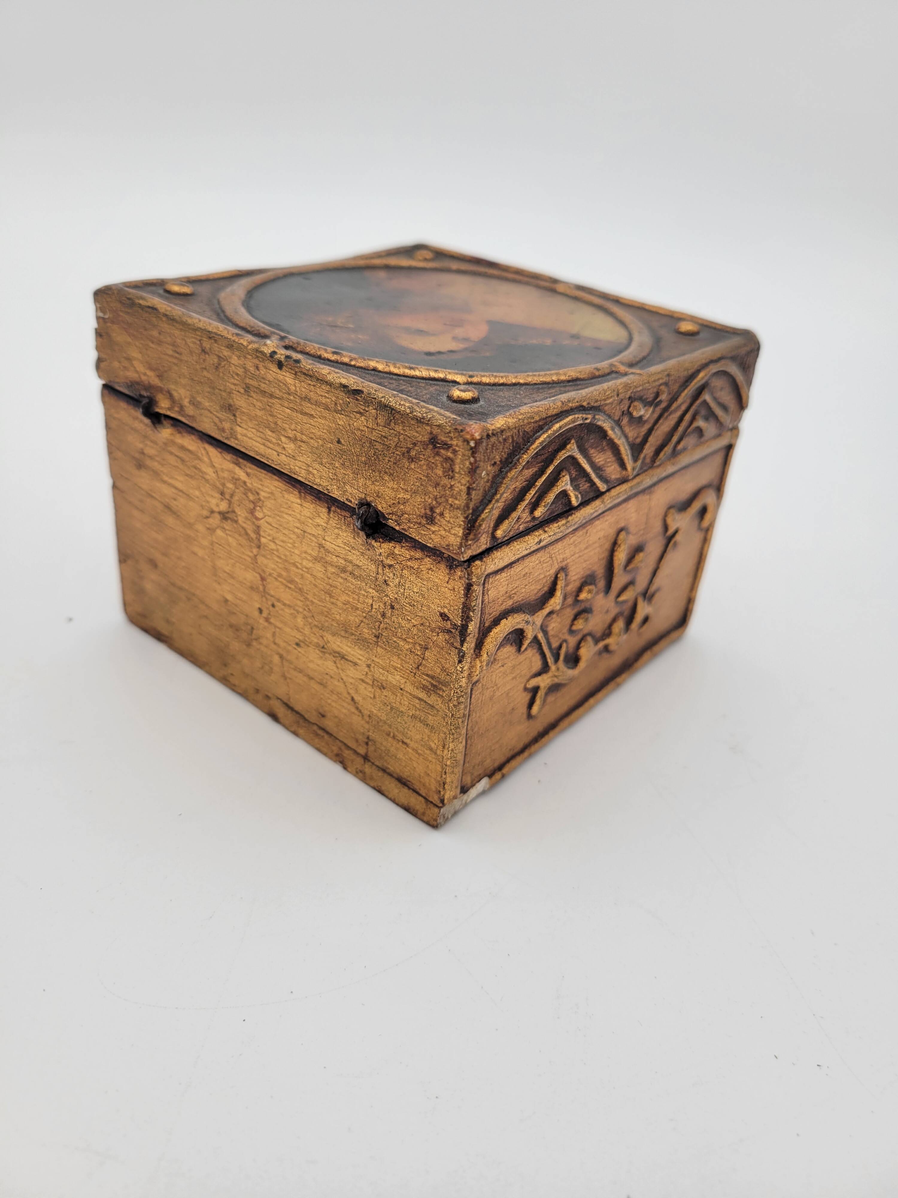 Old jewelry box in wood and gilded stucco