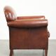Sheepskin armchair with comfortable seat and finished with decorative nails