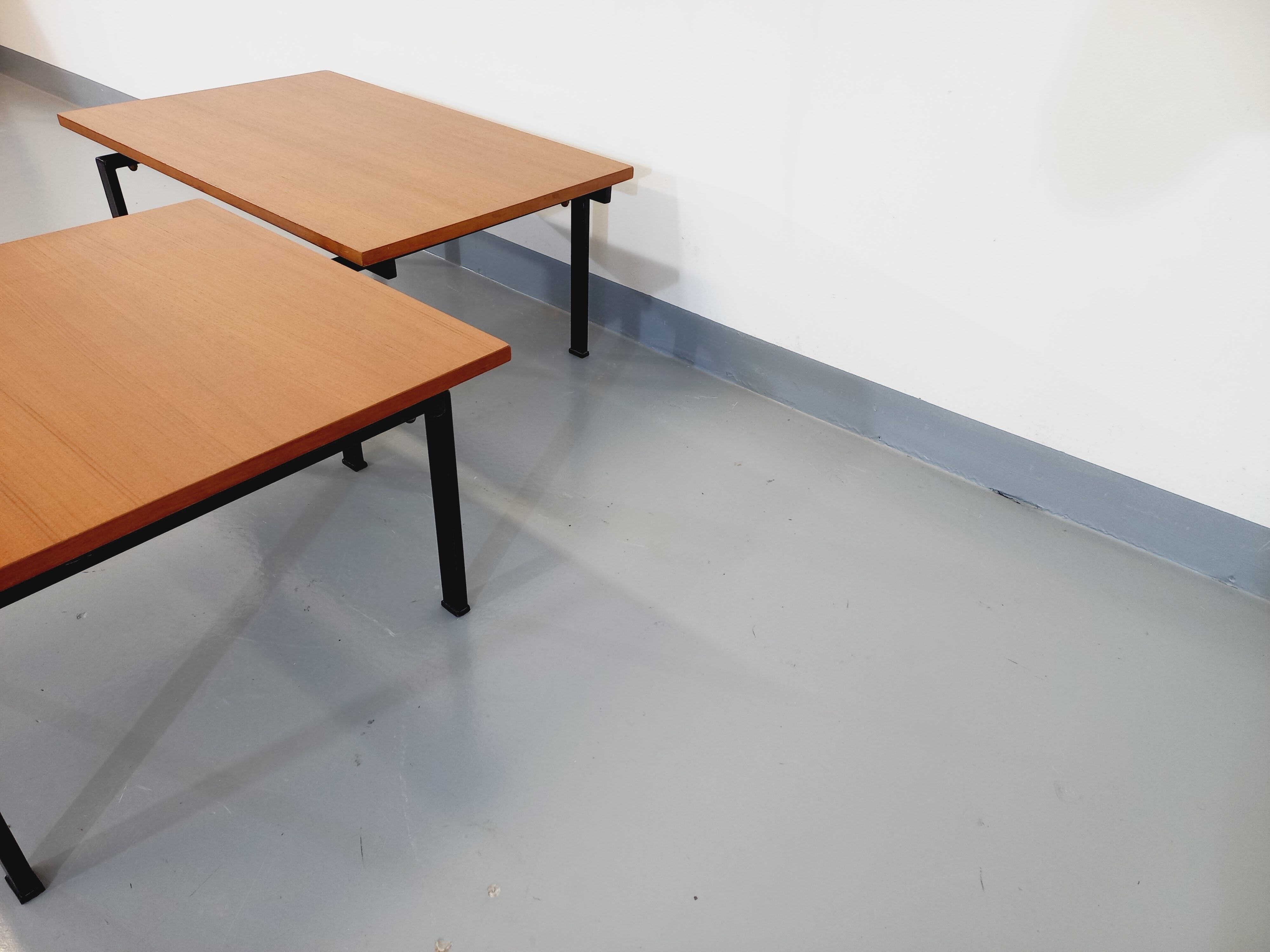 Suite of two vintage modernist Isa coffee tables in teak and black metal from the 60s