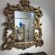 Gold wooden wall mirror with floral decoration
