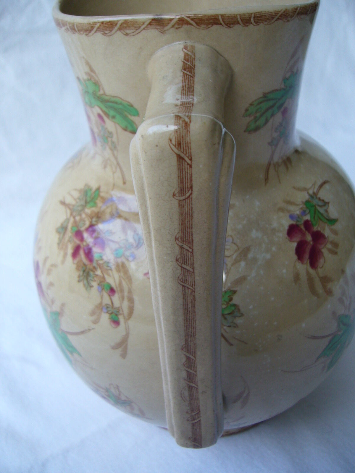 Antique pitcher decorated with flowers