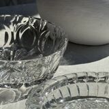 Circular glass ashtray with stylized petal patterns
