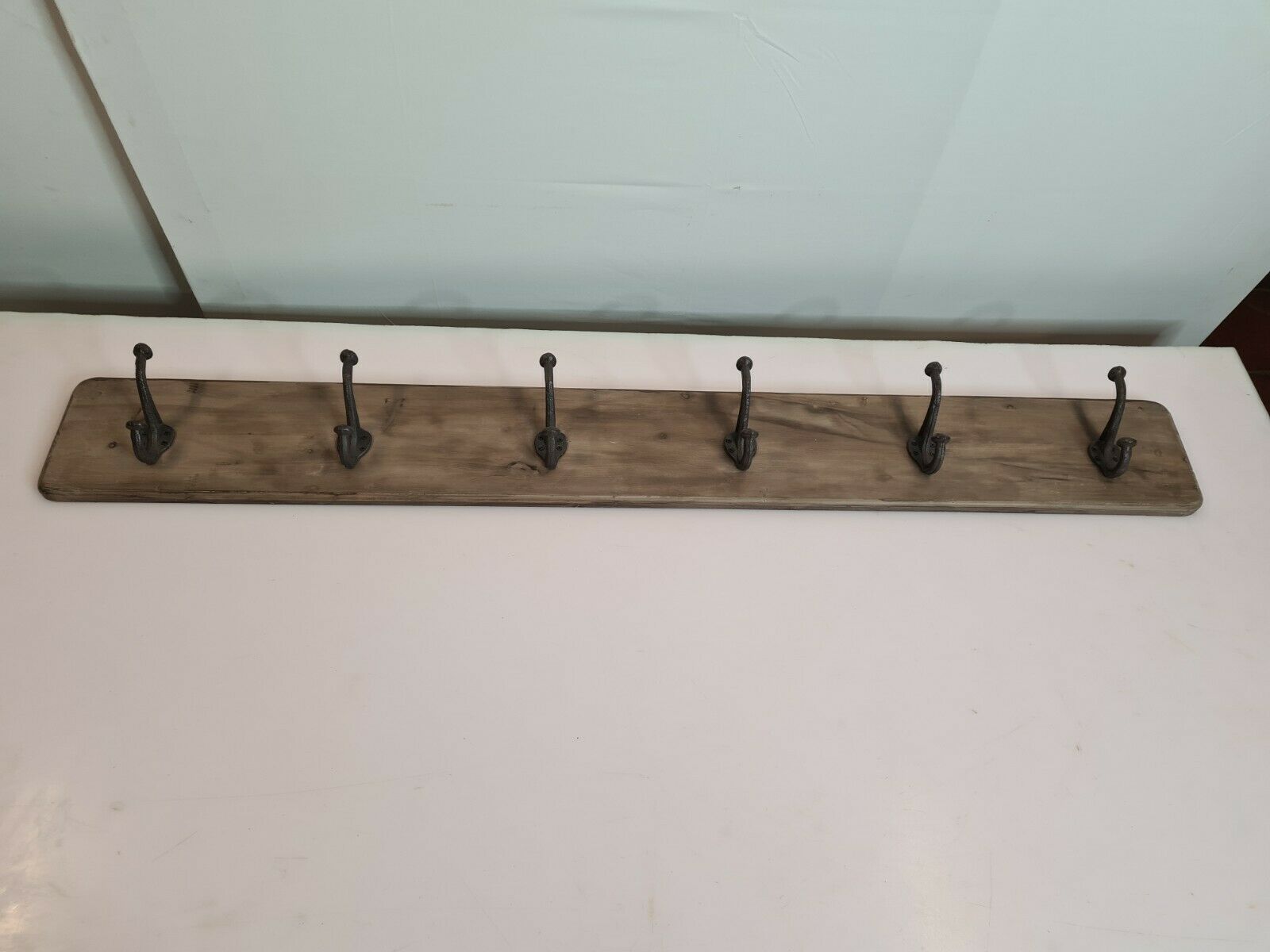 wooden school coat rack and iron hooks