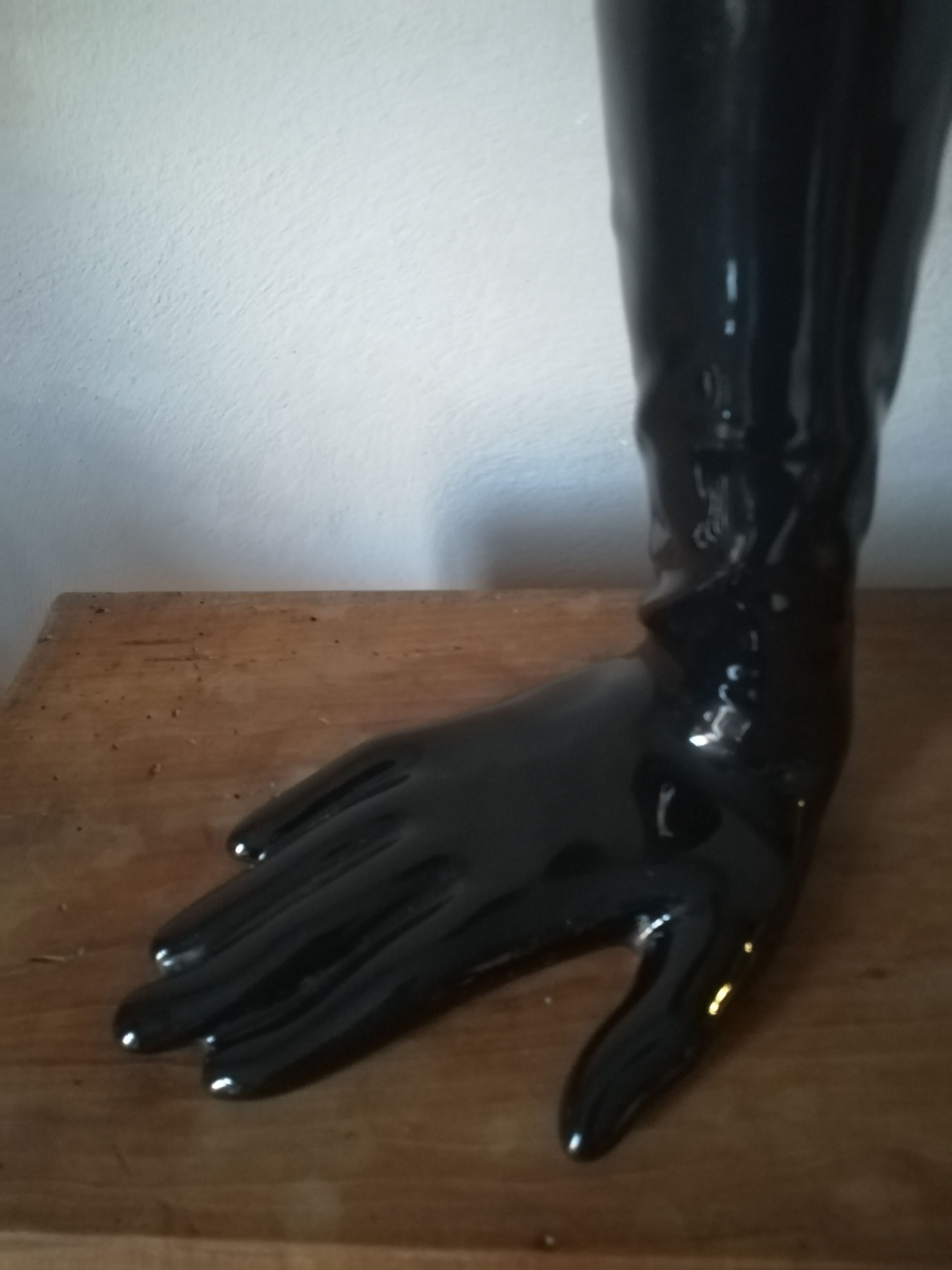 Black earthenware vase gloved hand