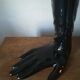 Black earthenware vase gloved hand