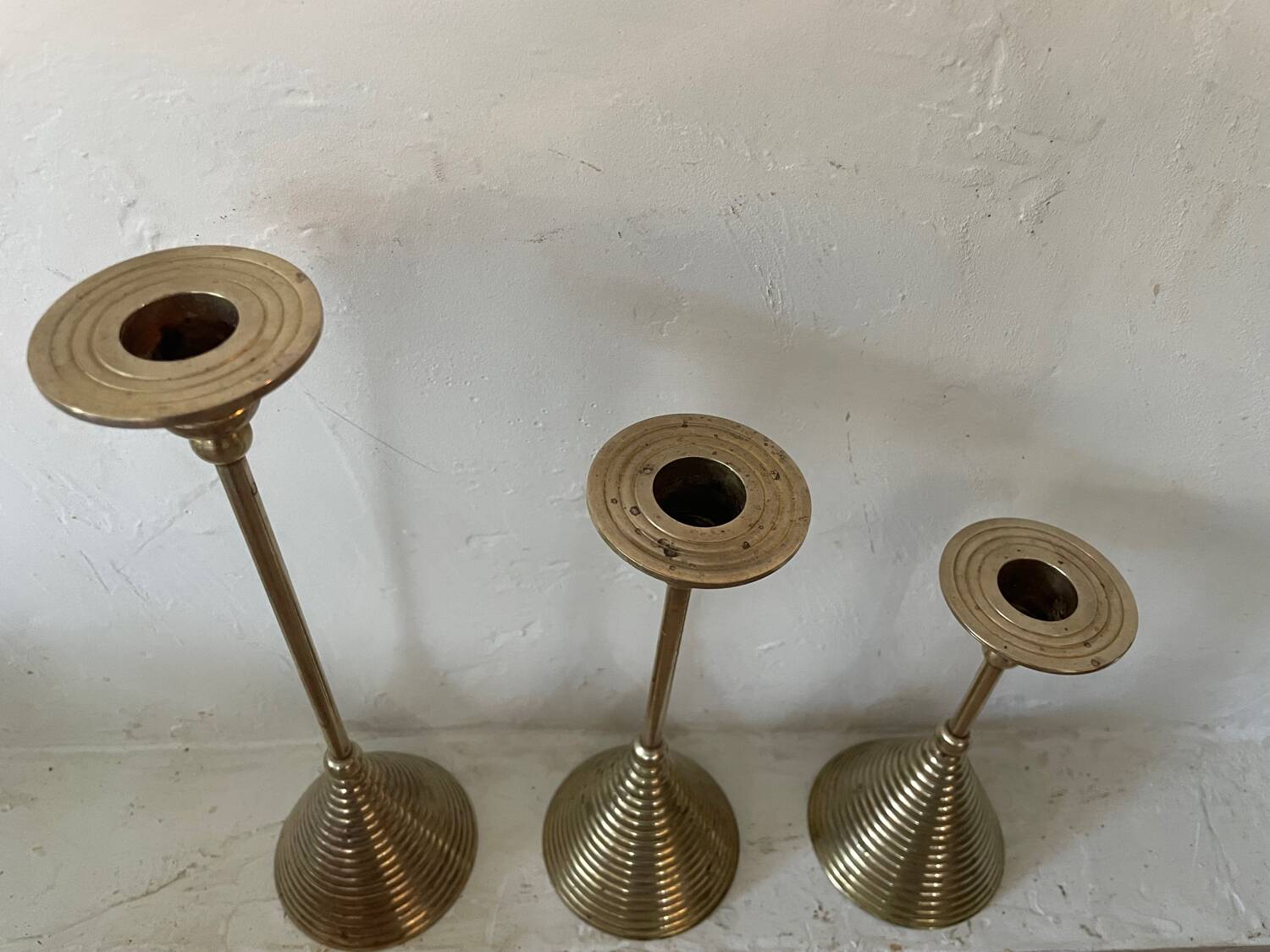 Set of three vintage brass candle holders