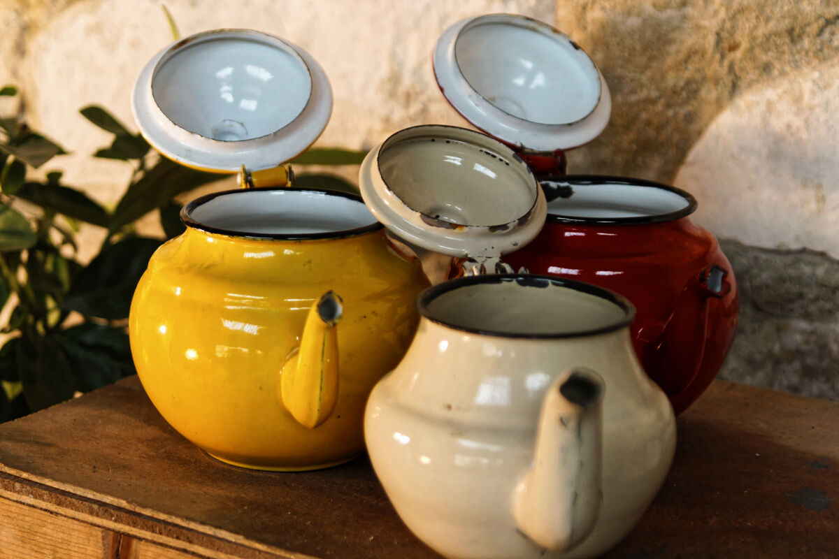 Trio of small enamelled teapots