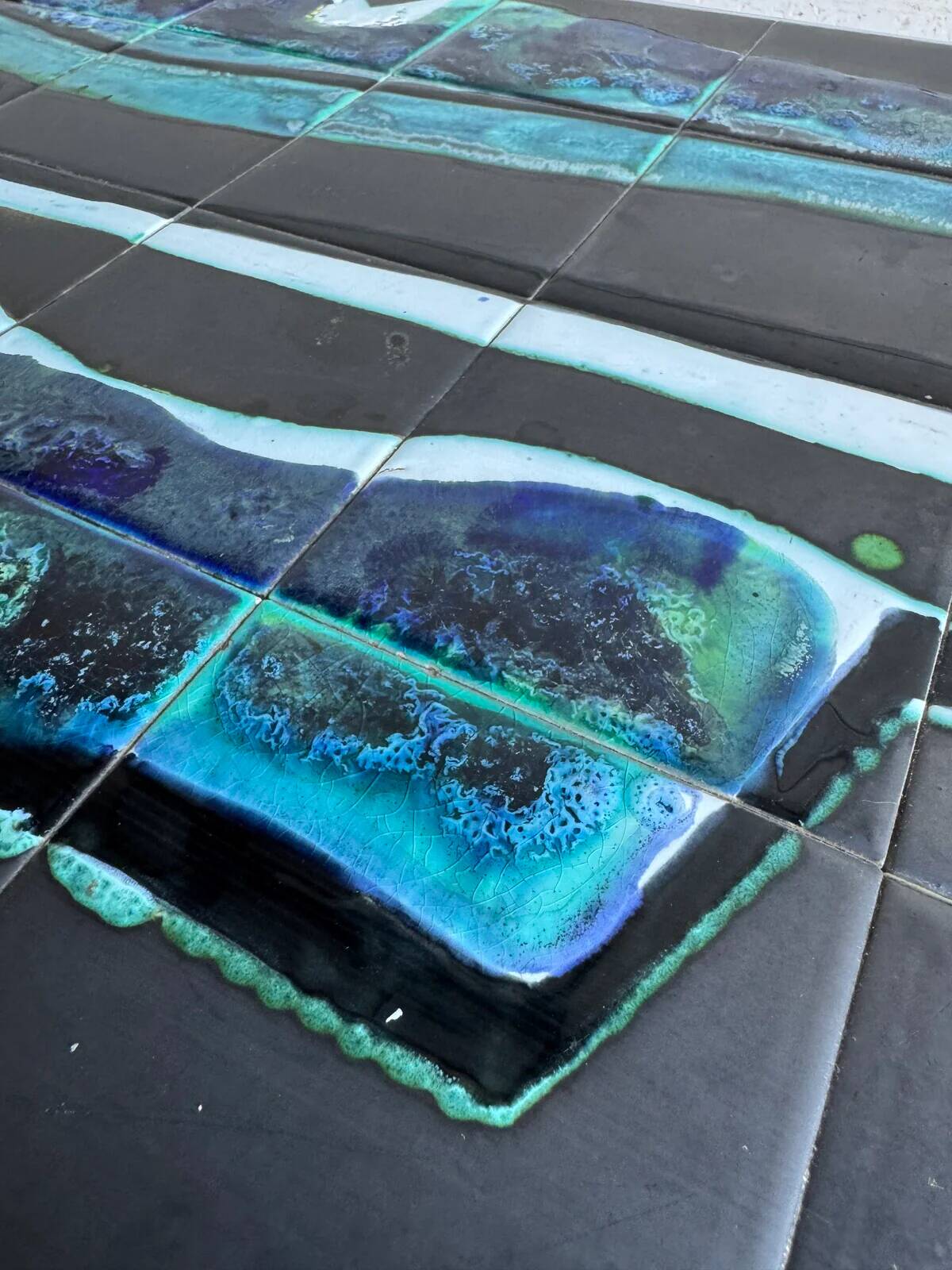 Mid-century Denisco ceramic coffee table — black, blue and white glazed tile top with silver metal base