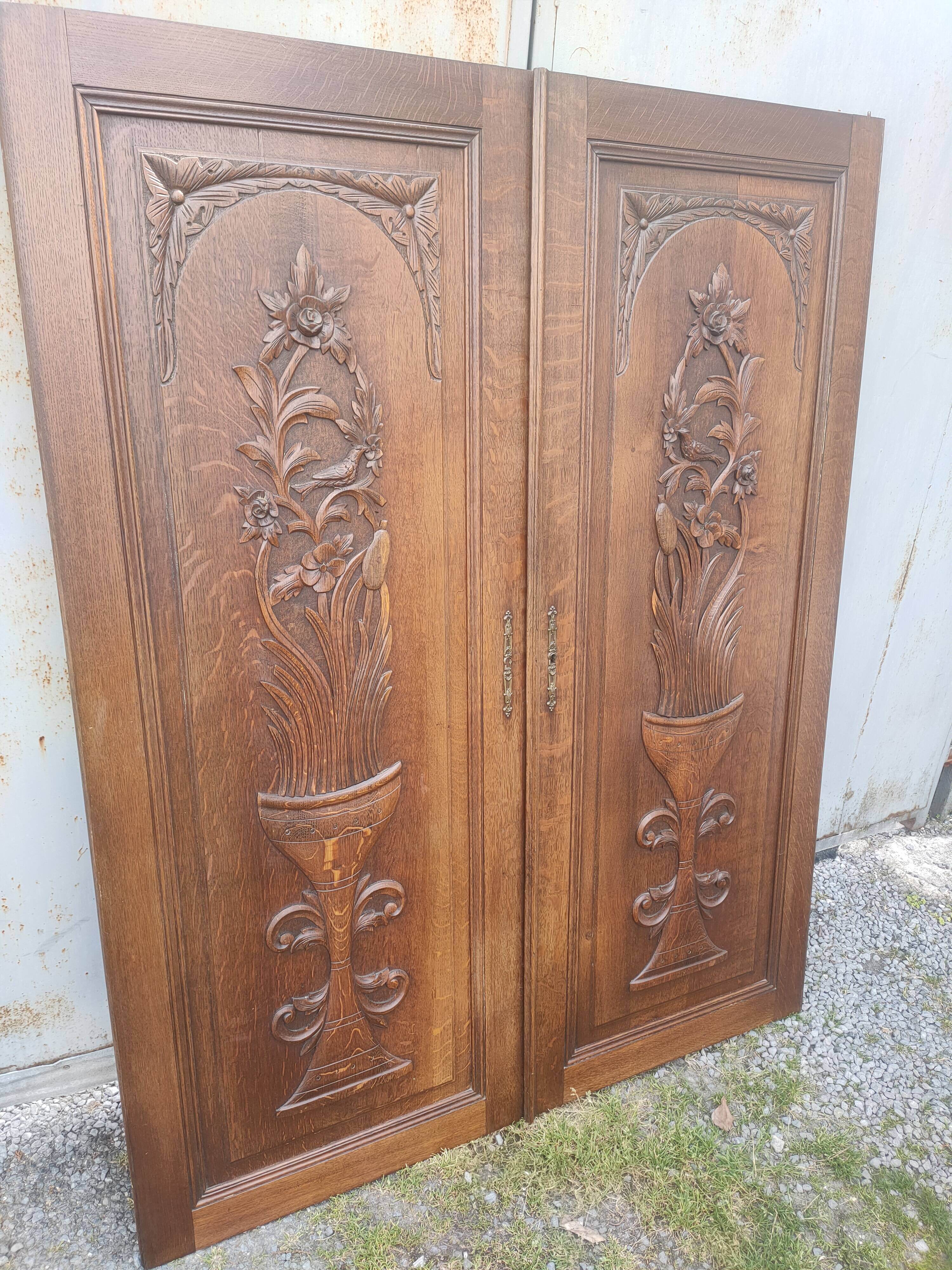 pair of antique solid oak cabinet doors with bird decor