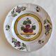 Two earthenware plates with fruits, pears and plums.